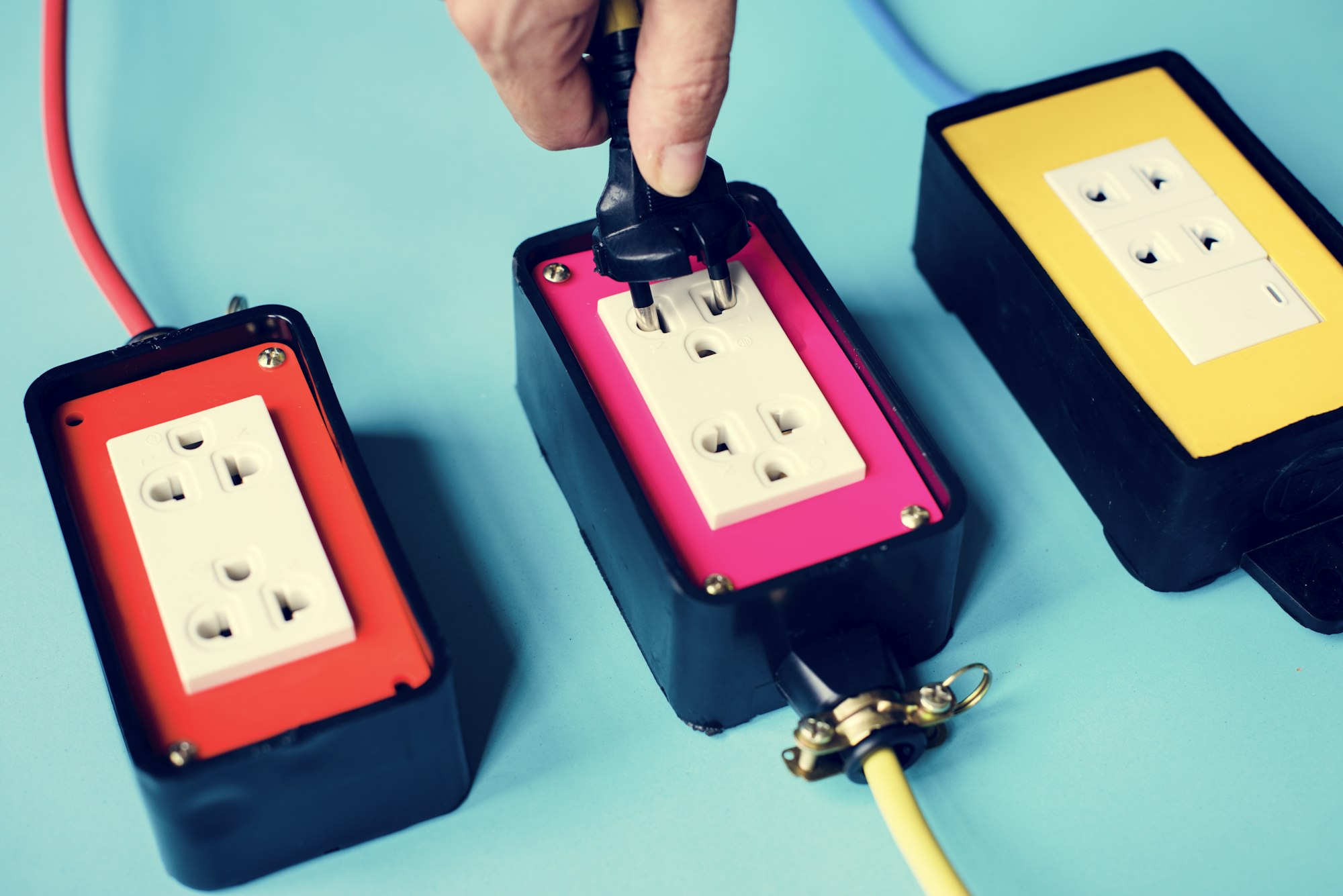 Electrical power supply plugs on blue background